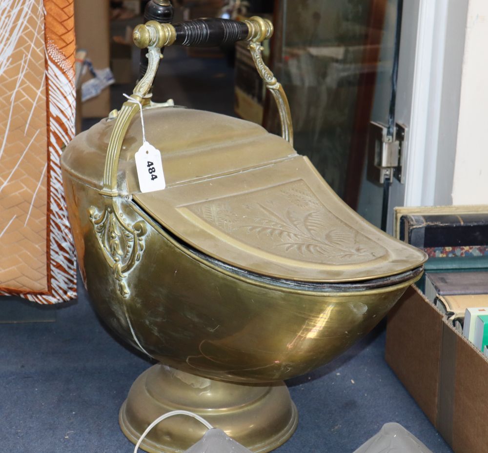 A helmet-shaped brass coal scuttle